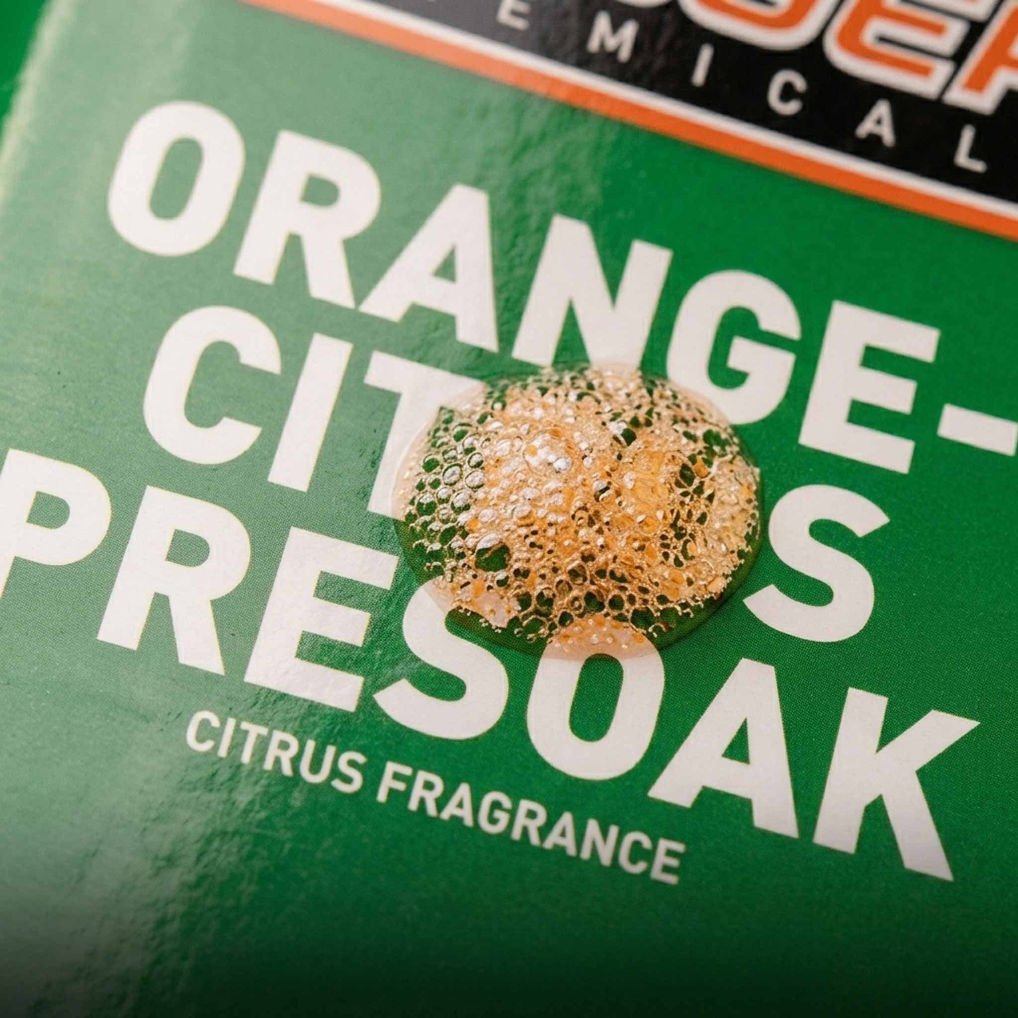 Product packaging with 'Orange Citrus Presoak' text and an orange-colored liquid on a green label.