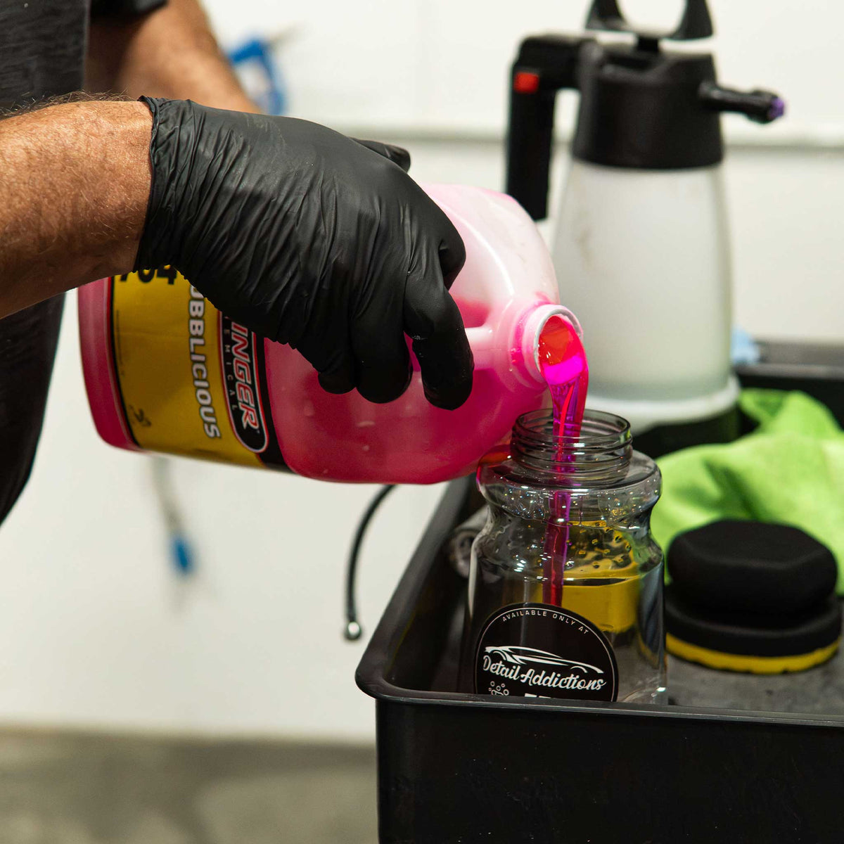Stinger Chemical Bubblicious 704 pink soap poured into a clear foam cannon bottle