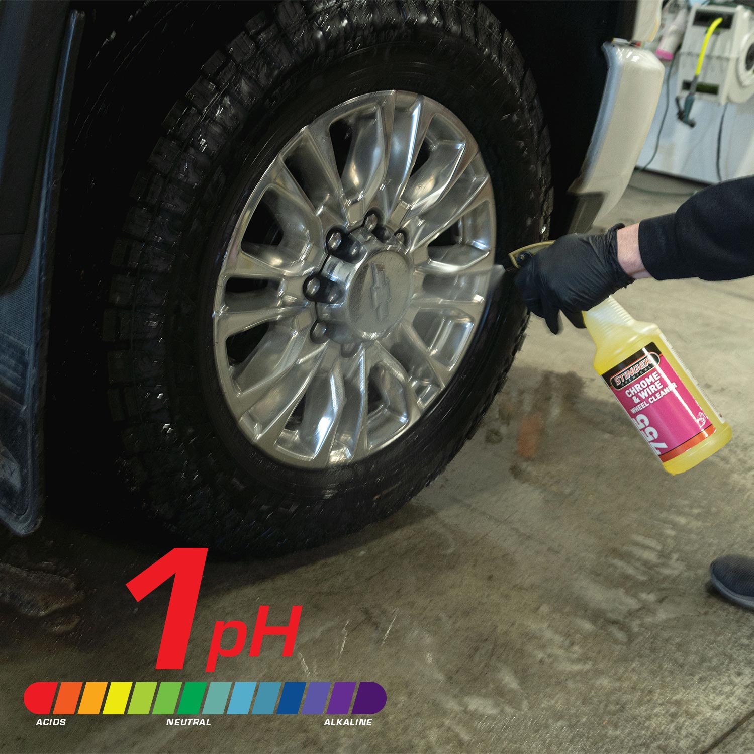 Person cleaning a car wheel with a spray bottle labeled 'Chrone & Wire Wheel Cleaner' on a concrete surface.