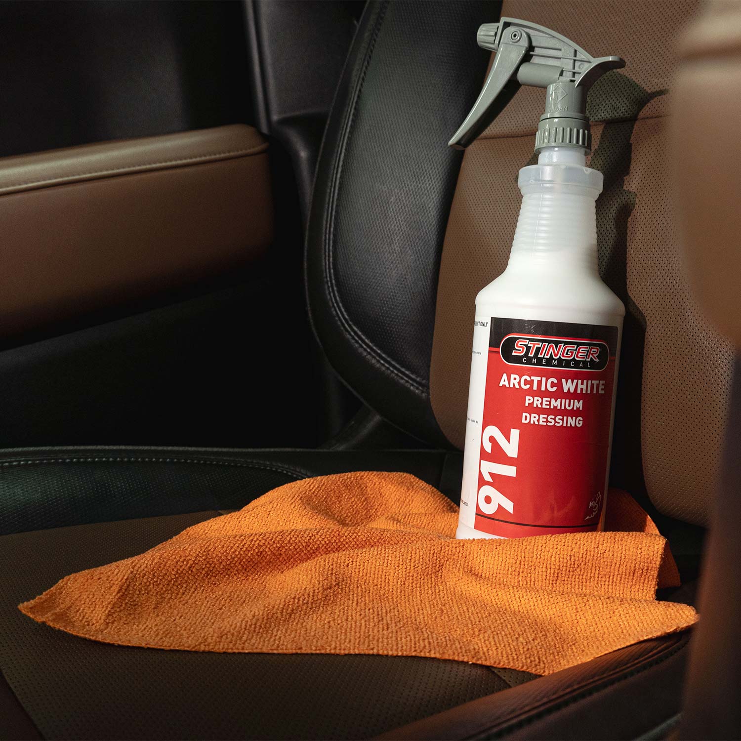 Stinger Arctic White Premium Dressing bottle with a towel on a car seat