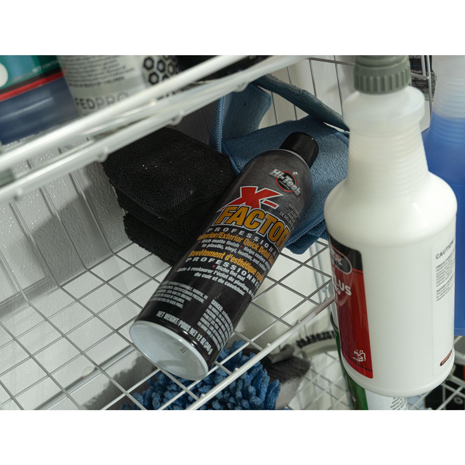 X-factor cleaning product on a metal shelf with tiled floor in the background