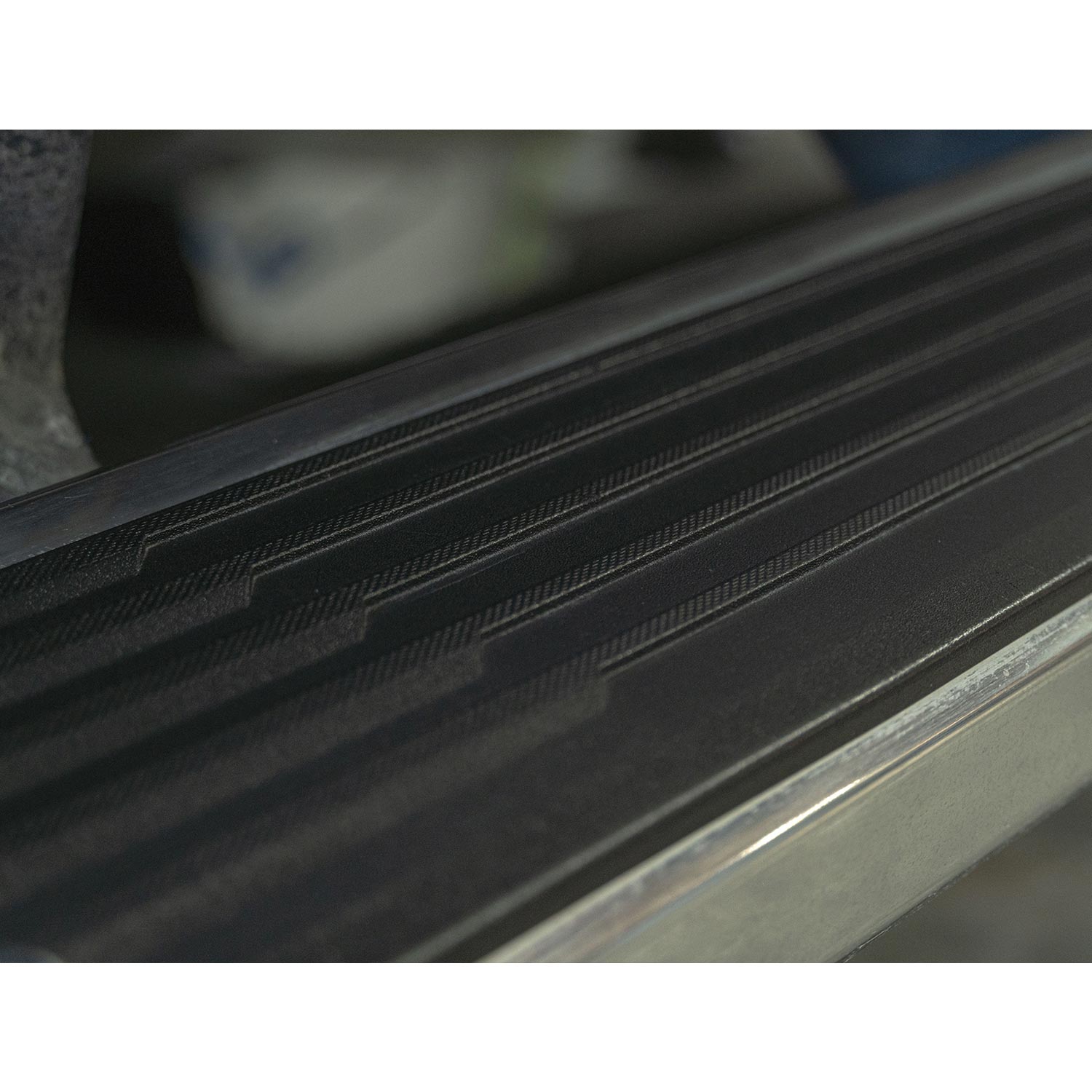 Close-up of a car stepping panel with a vinyl dressing on it