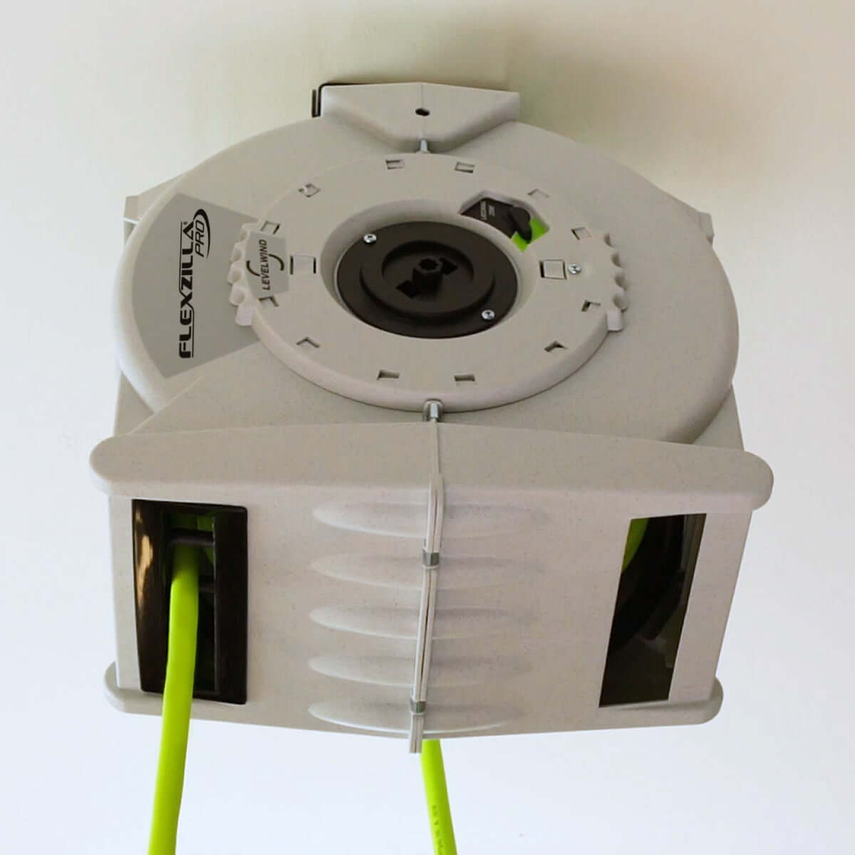 Flexzilla cable management reel with green hose on a white garage ceiling