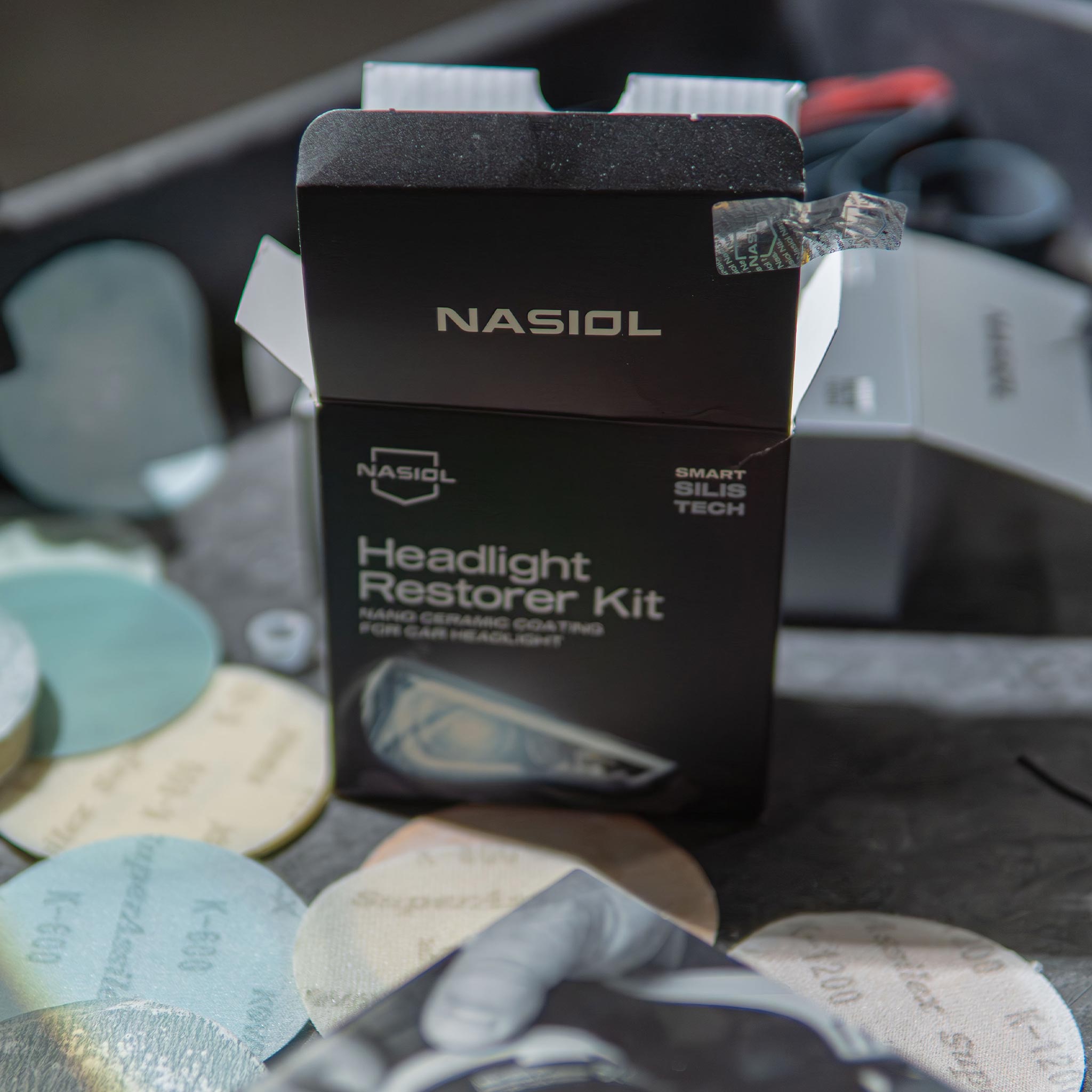 nasiol headlight restorer kit torn open in a shop cart background