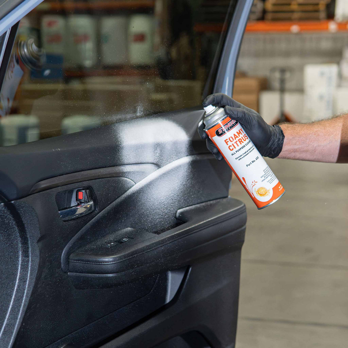Stinger Chemical Foamy Citrus 600 foaming cleaner sprayed on a vinyl car door panel