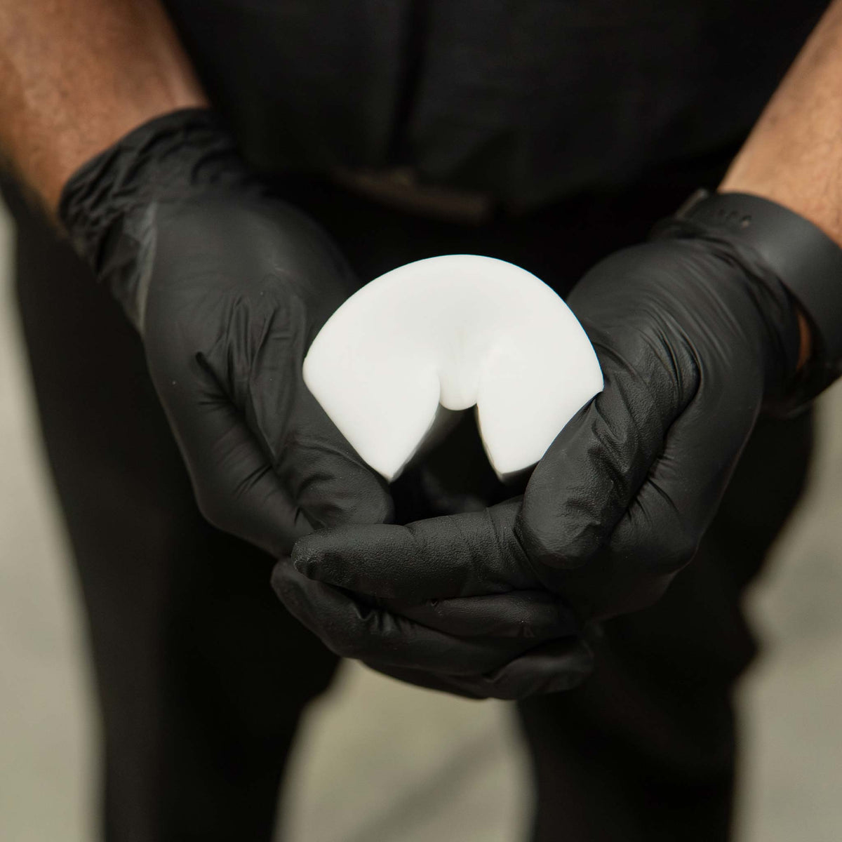 Stinger Chemical Heavy Duty Magic Nano Sponge bent in gloved hands to show the flexible foam