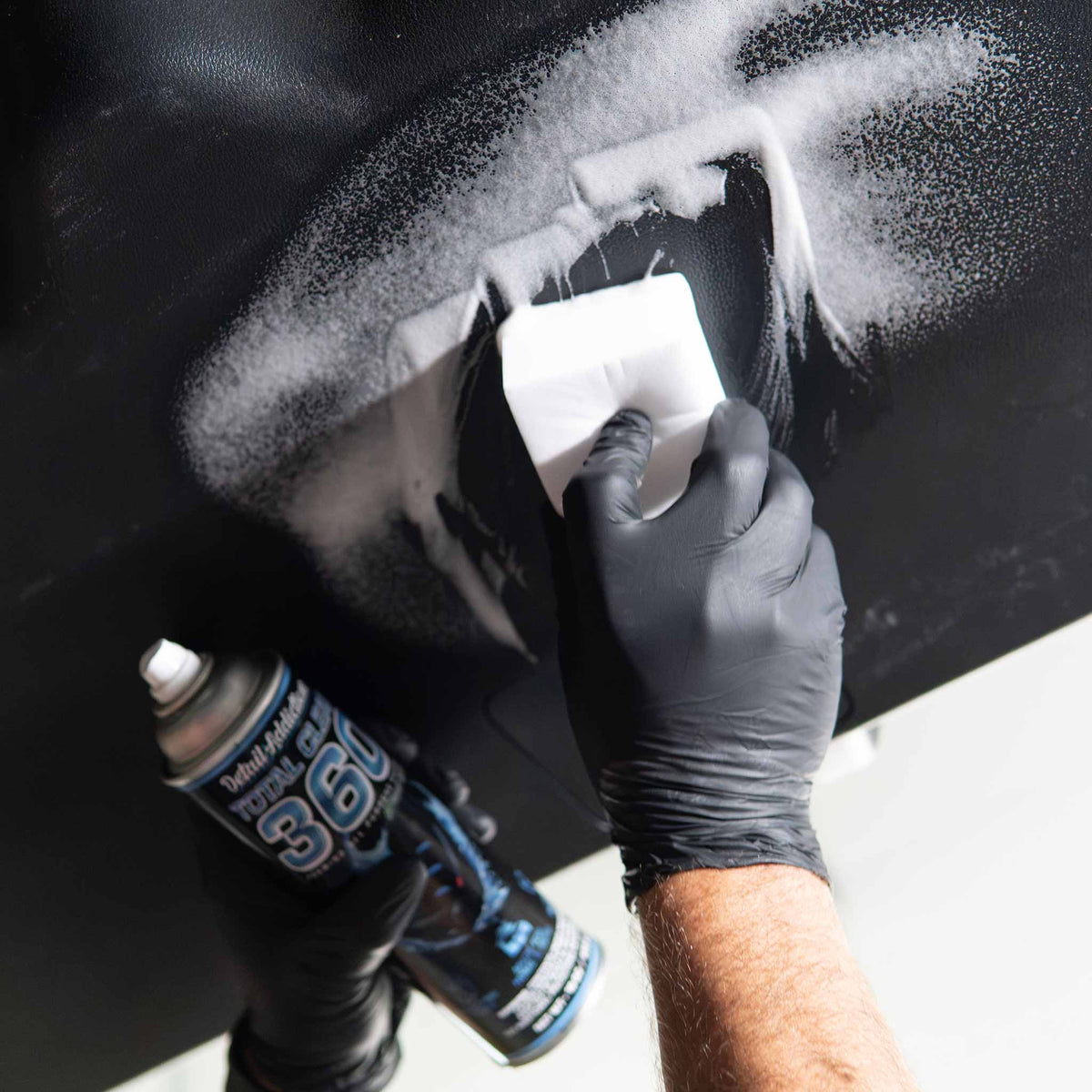 Stinger Chemical Heavy Duty Magic Nano Sponge scrubbing Total Clean 360 foam on a black painted panel