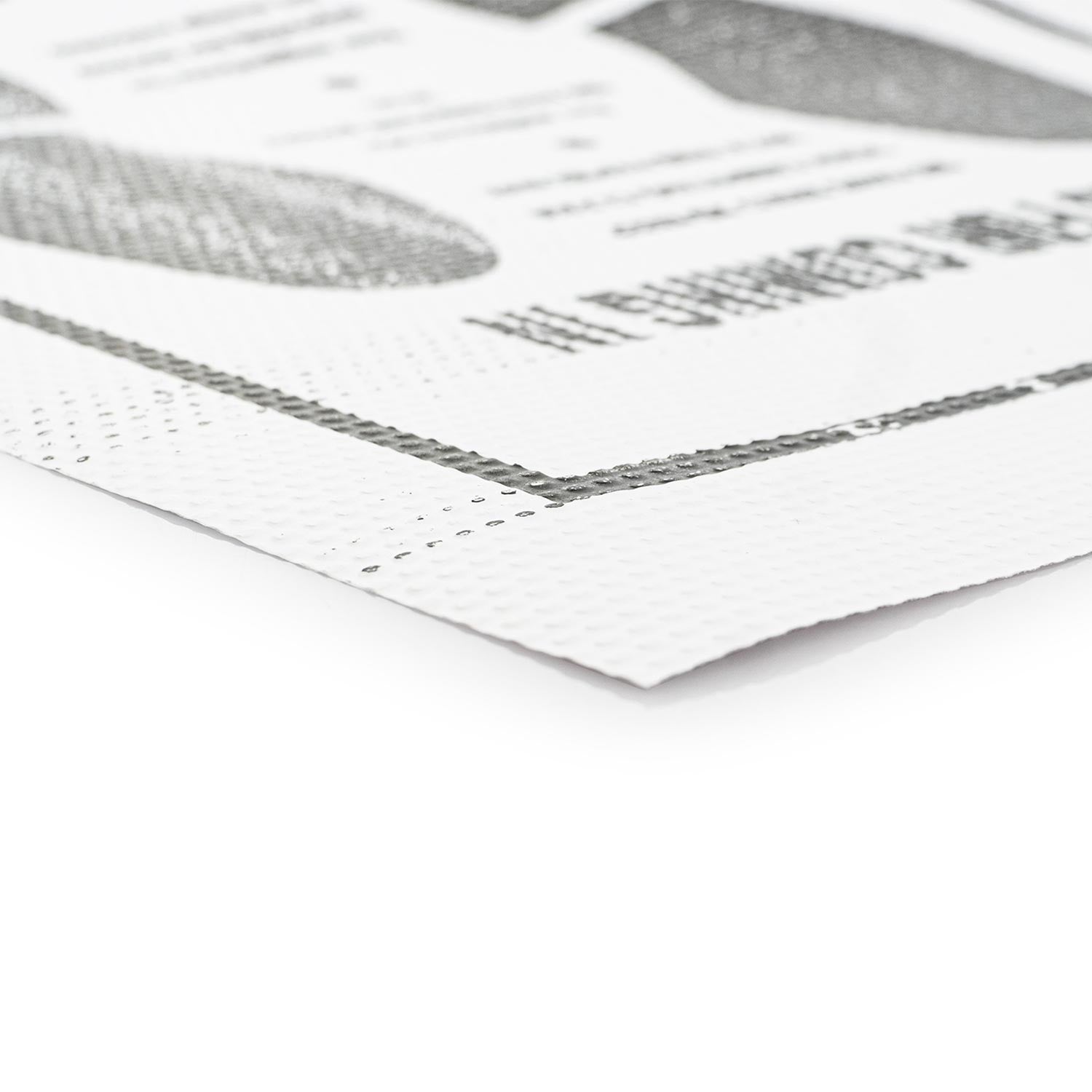 Close-up of a paper floor mat with text and images on a white background