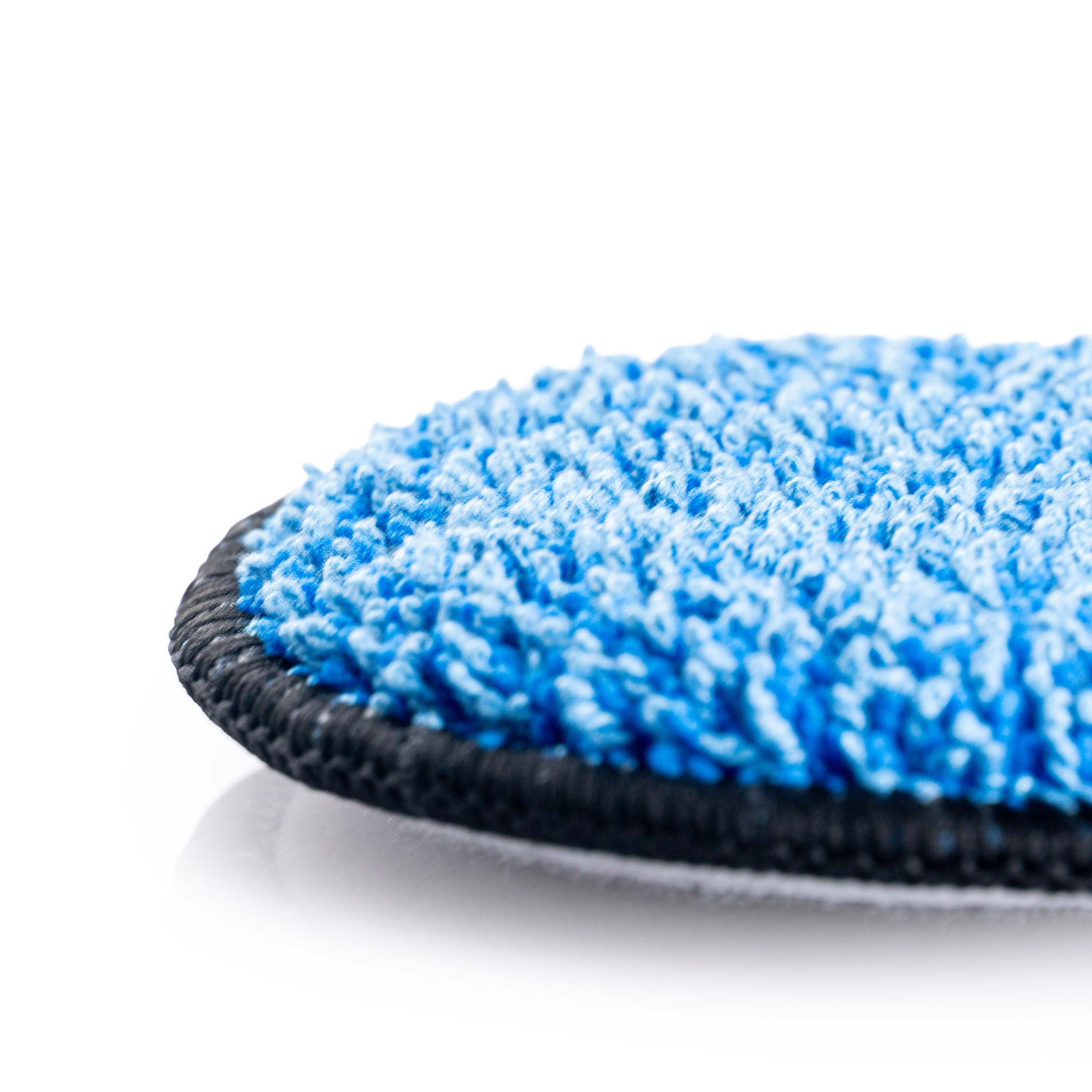 Close-up of a blue microfiber cleaning pad on a white background