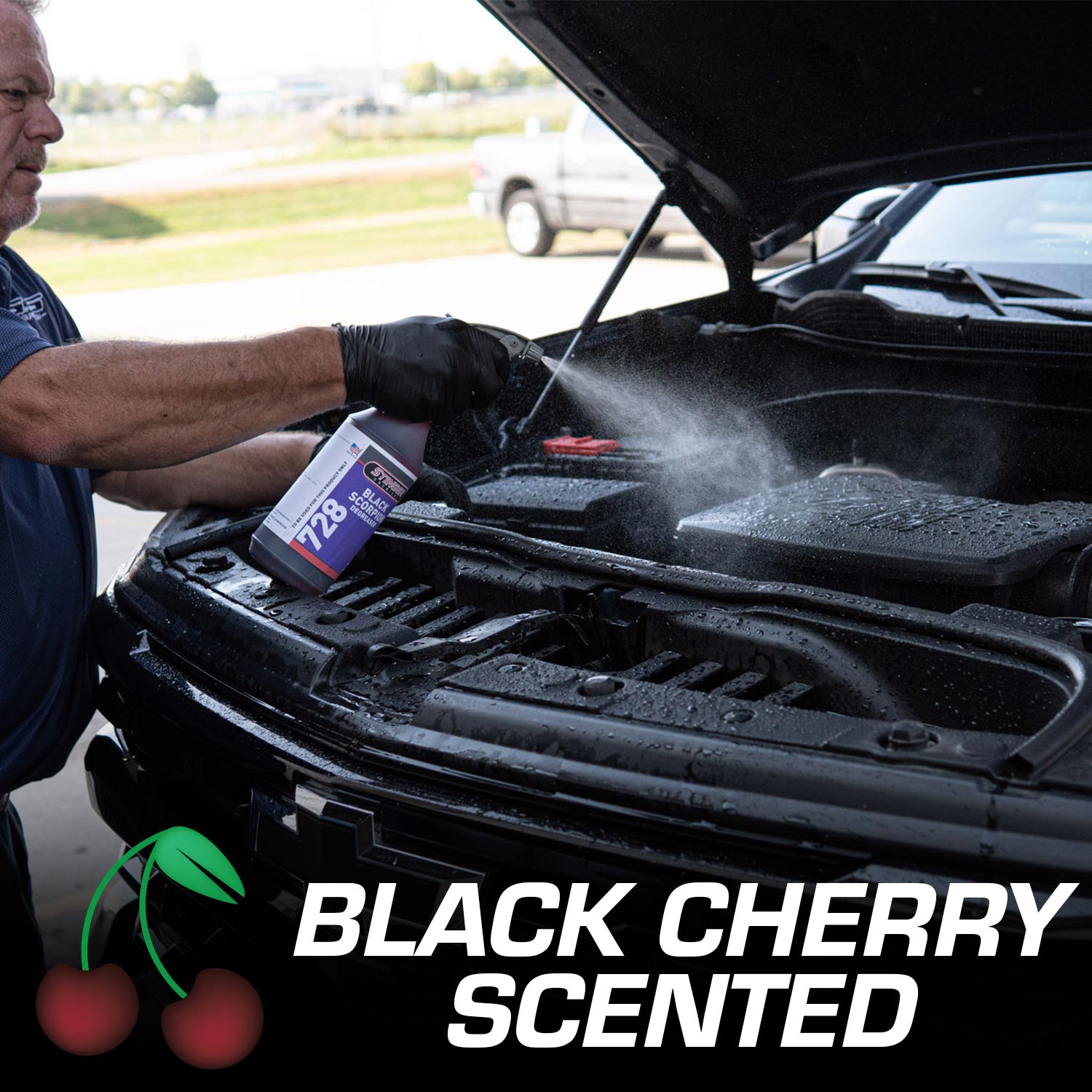 man spraying black scoprion degreaser on a truck engine with black cherry scent on image