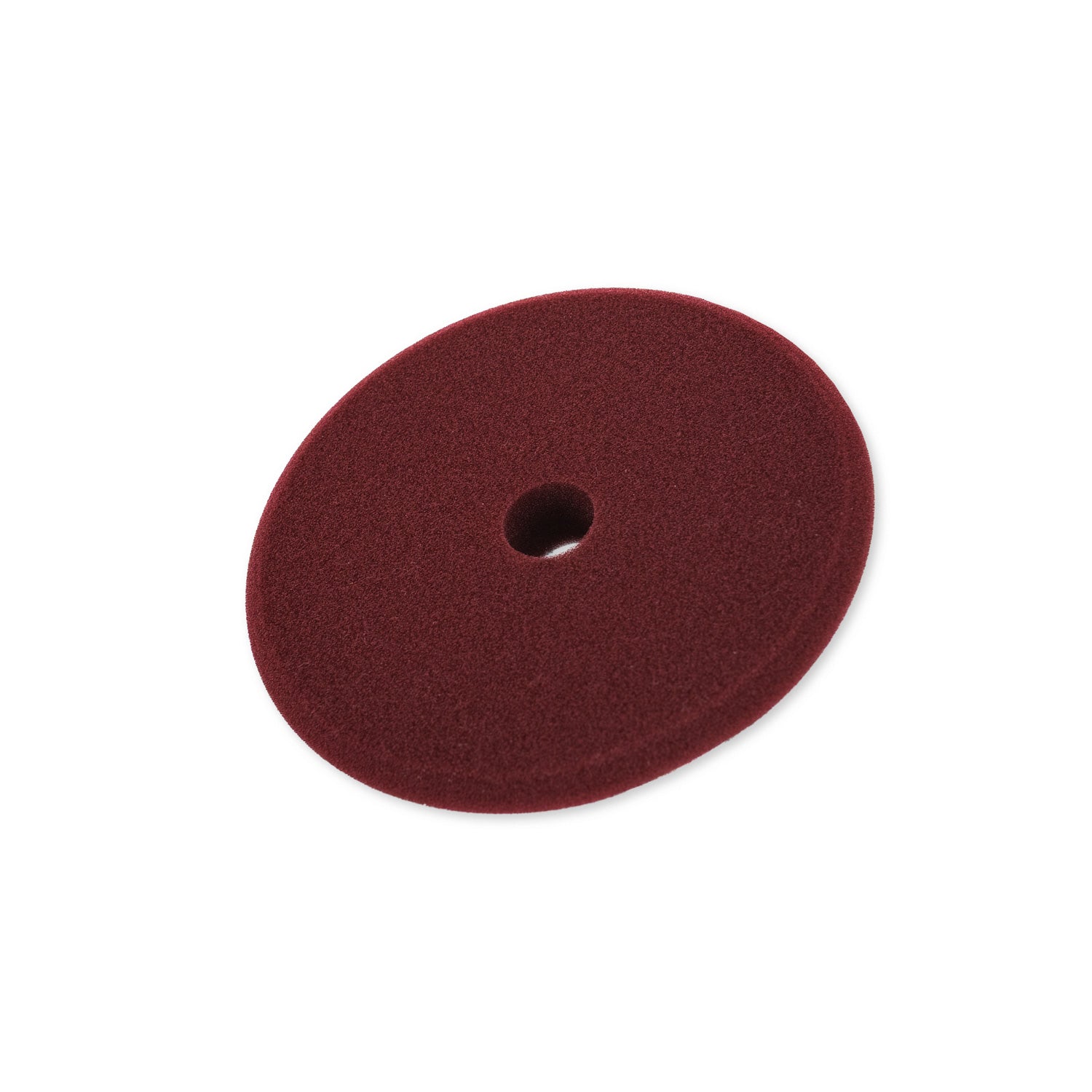 Maroon foam buffing pad on a white background