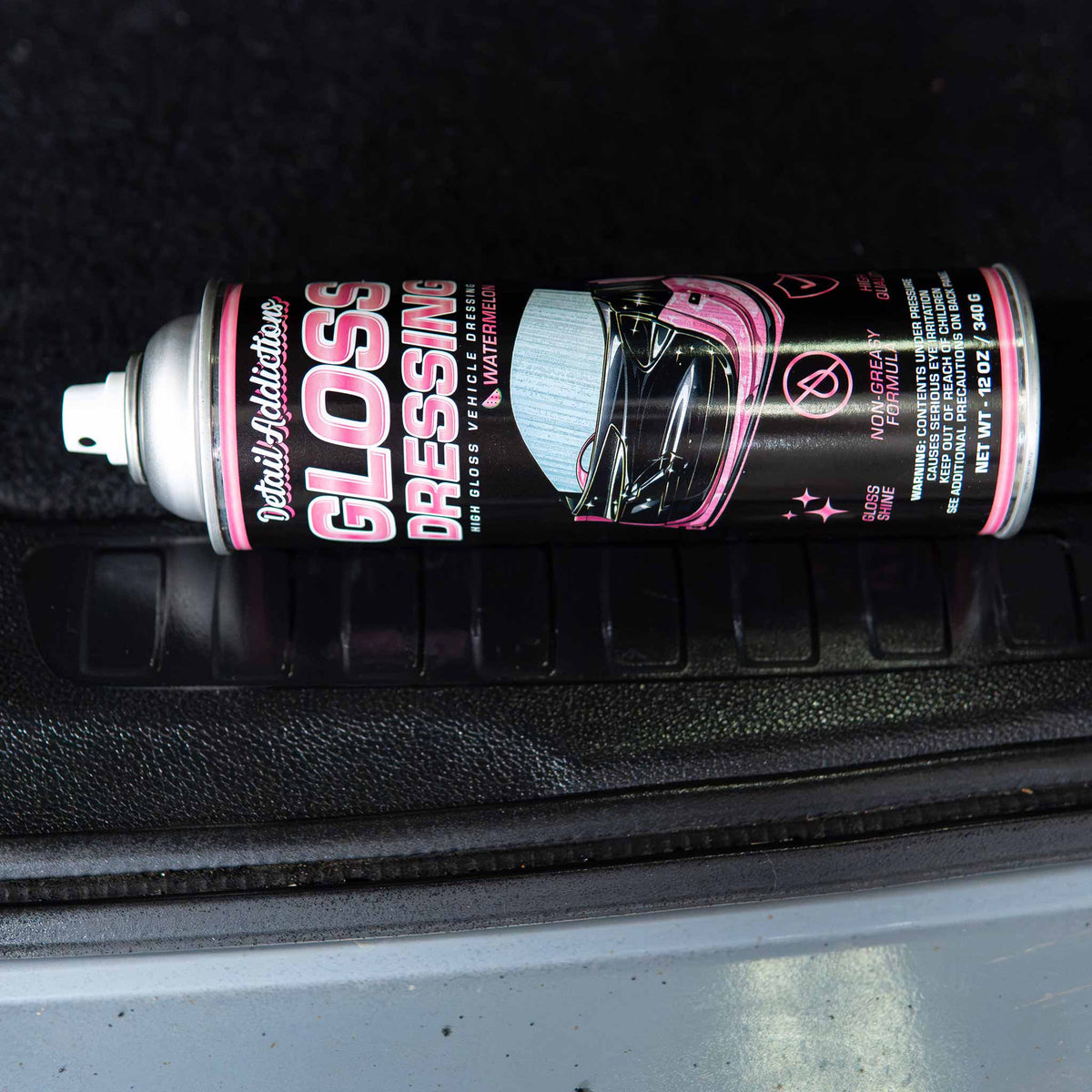 Detail Addictions Premium Gloss Dressing can reflected in glossy black plastic trunk trim