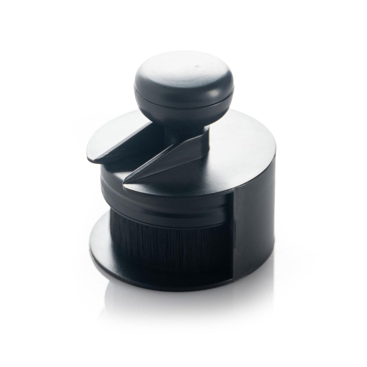 Detail Addictions tire and trim brush seated in its included black storage stand