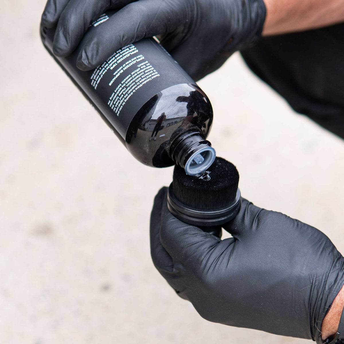 Nasiol Detailer Shine tire dressing poured onto a black tire applicator brush