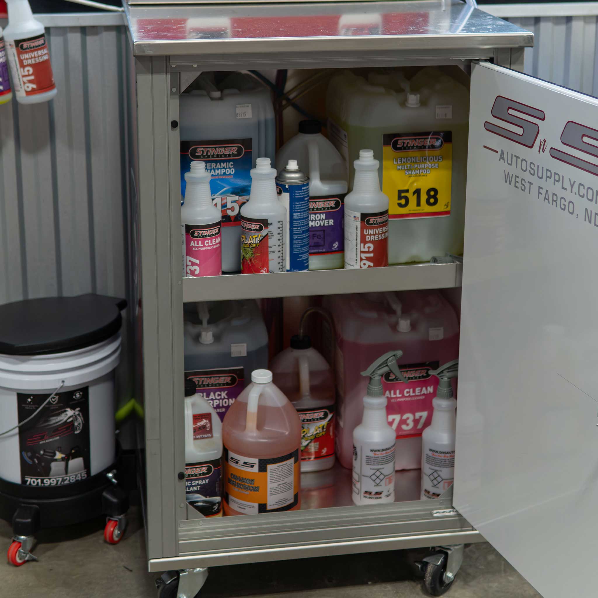 mobile mixing station cabinet with automotive supplies including bottles and containers on wheels.