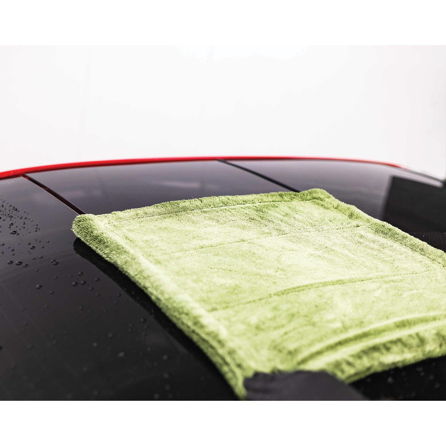 Green M22 microfiber towel on a car's black roof