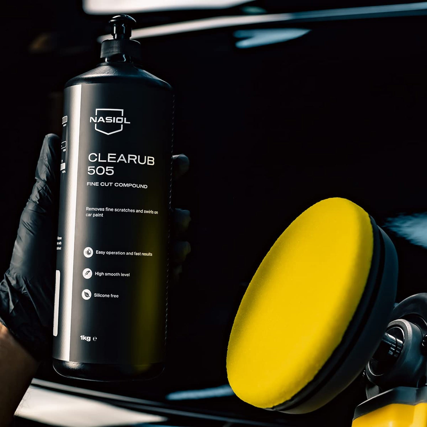 Nasiol Clearub 505 car polish compound bottle with a yellow polish pad on a black background