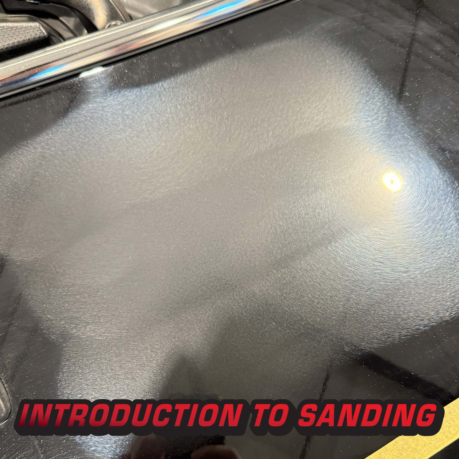 Car clear coat with sanding residue and text 'Introduction to Sanding' at the bottom.