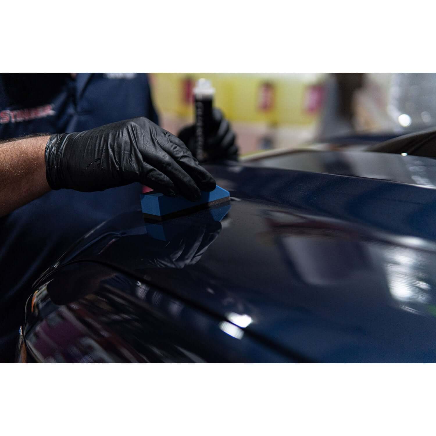 ceramic coating application on a blue truck hood
