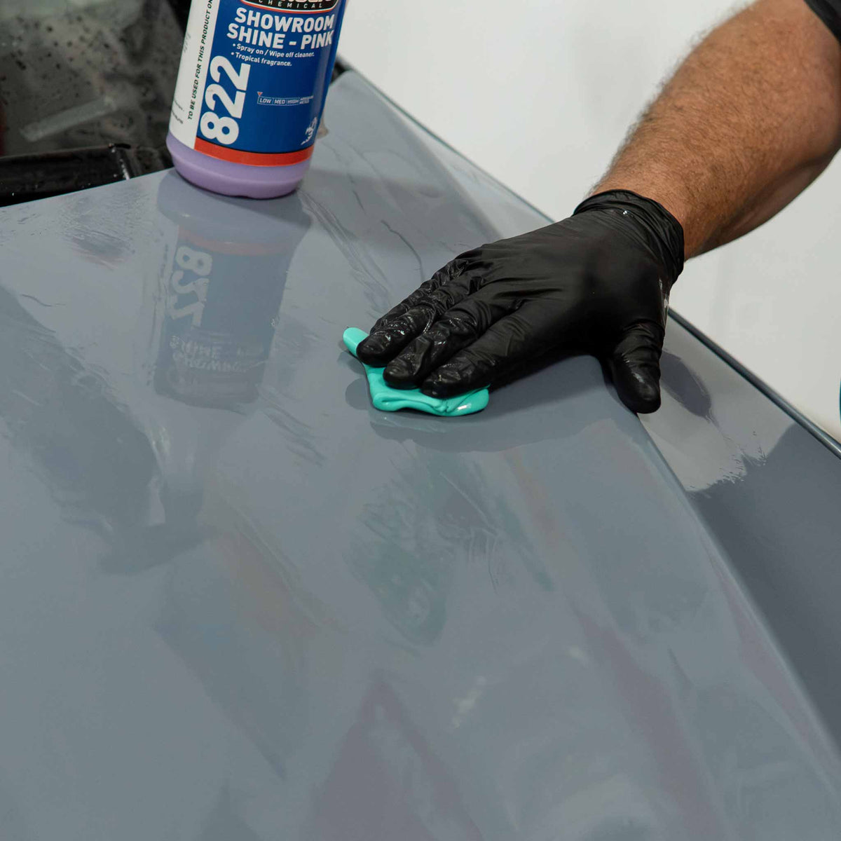 Claying a gray hood with Stinger fine clay and 822 Showroom Shine as clay lubricant
