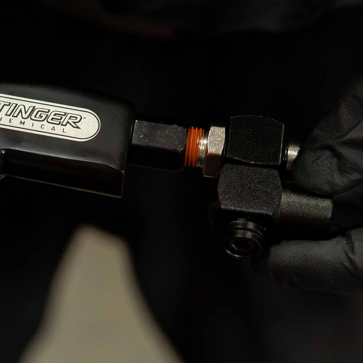 Stinger Twister 90 degree swivel adapter being threaded into a blow gun air inlet