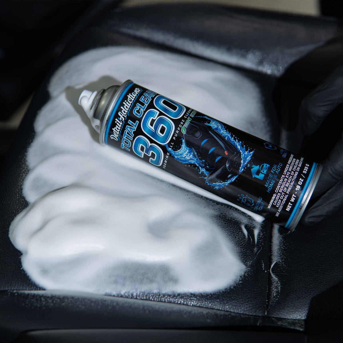 Detail Addictions Total Clean 360 semi-neutral cleaner foam covering a black leather car seat