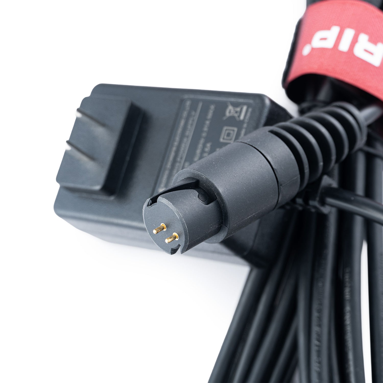 Close-up of a Scangrip power adapter with a cable on a white background