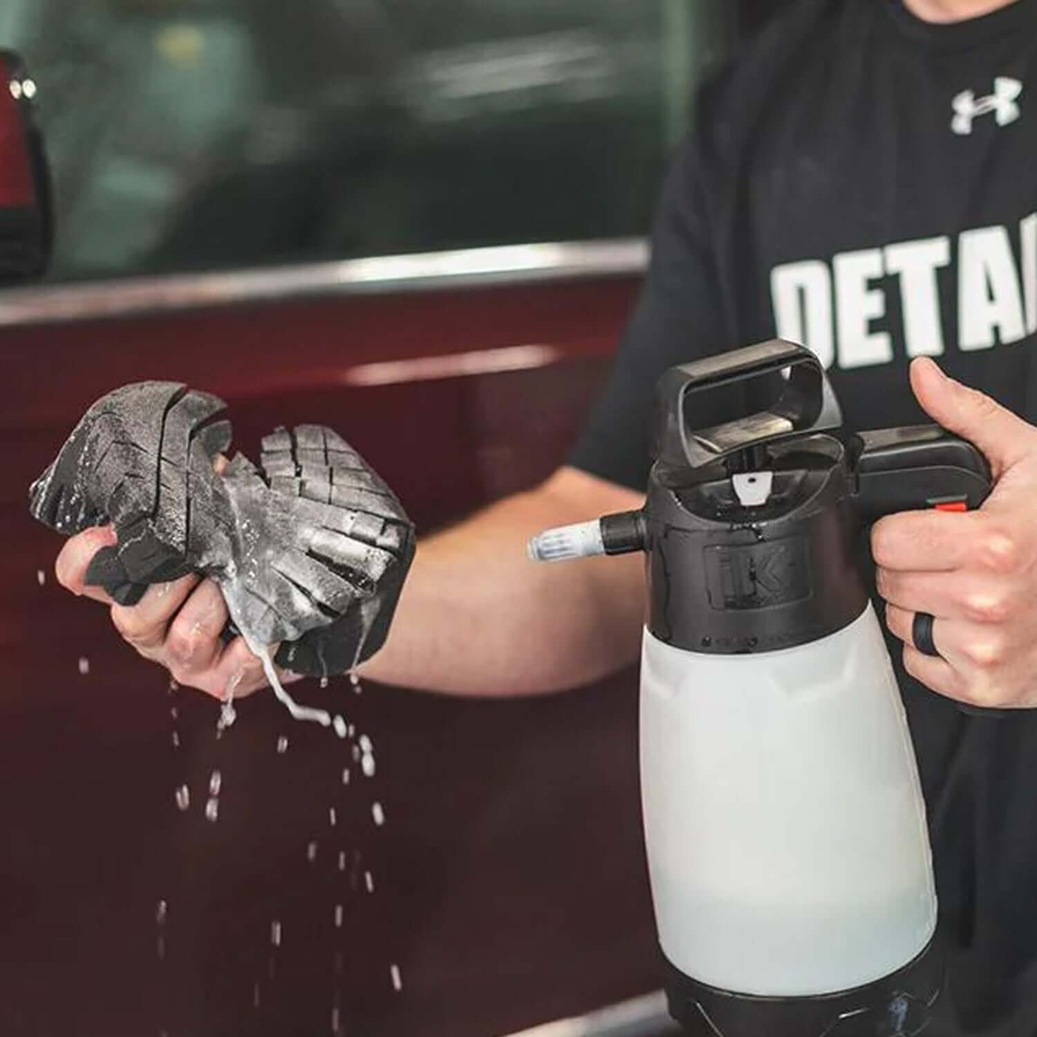 Ultra Safe Sponge being used in a rinseless wash application on a maroon vehicle