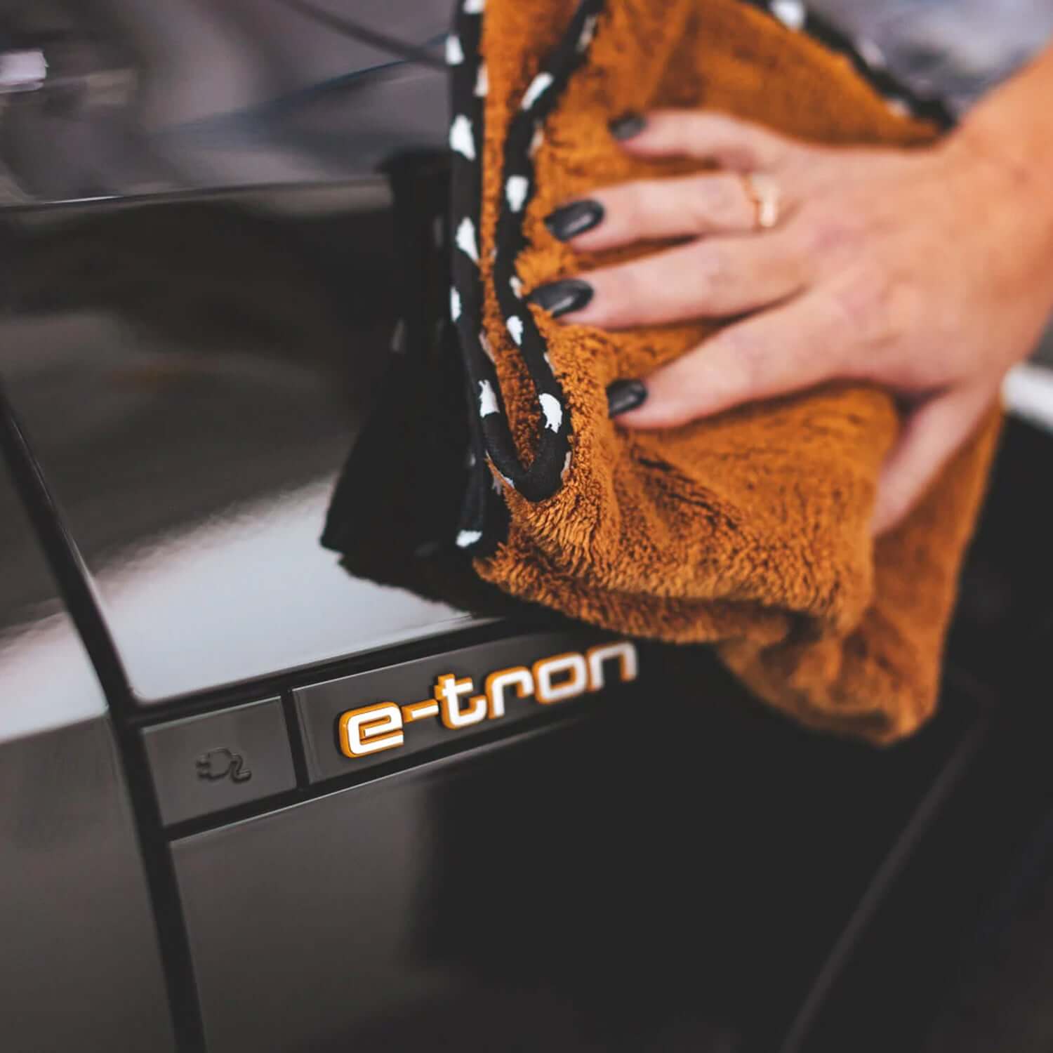 the-wolf-pack-drying-towel-on-e-tron-vehicle
