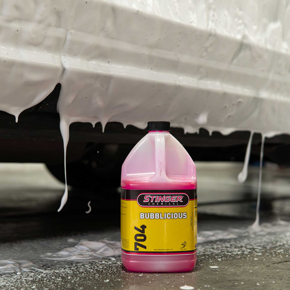 Stinger Chemical Bubblicious 704 gallon jug with foam running off a vehicle behind it