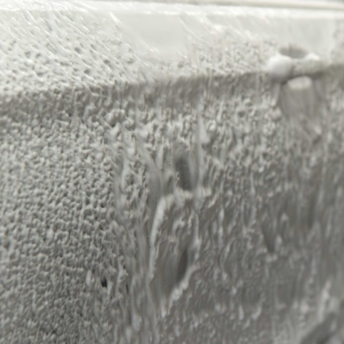 Stinger Chemical Bubblicious 704 thick white foam clinging to a car panel