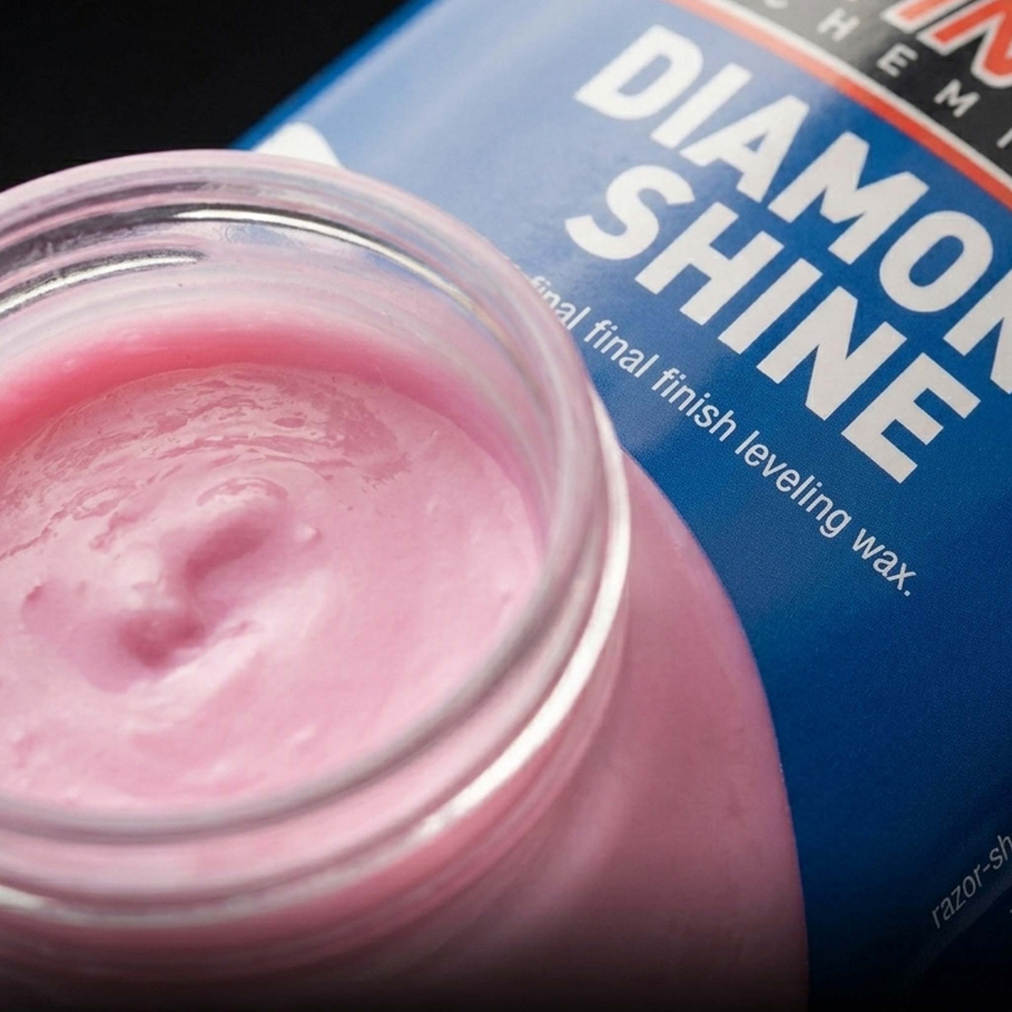 Pink polish in a jar with a blue and white gallon jug labeled 'Diamond Shine' in the background.