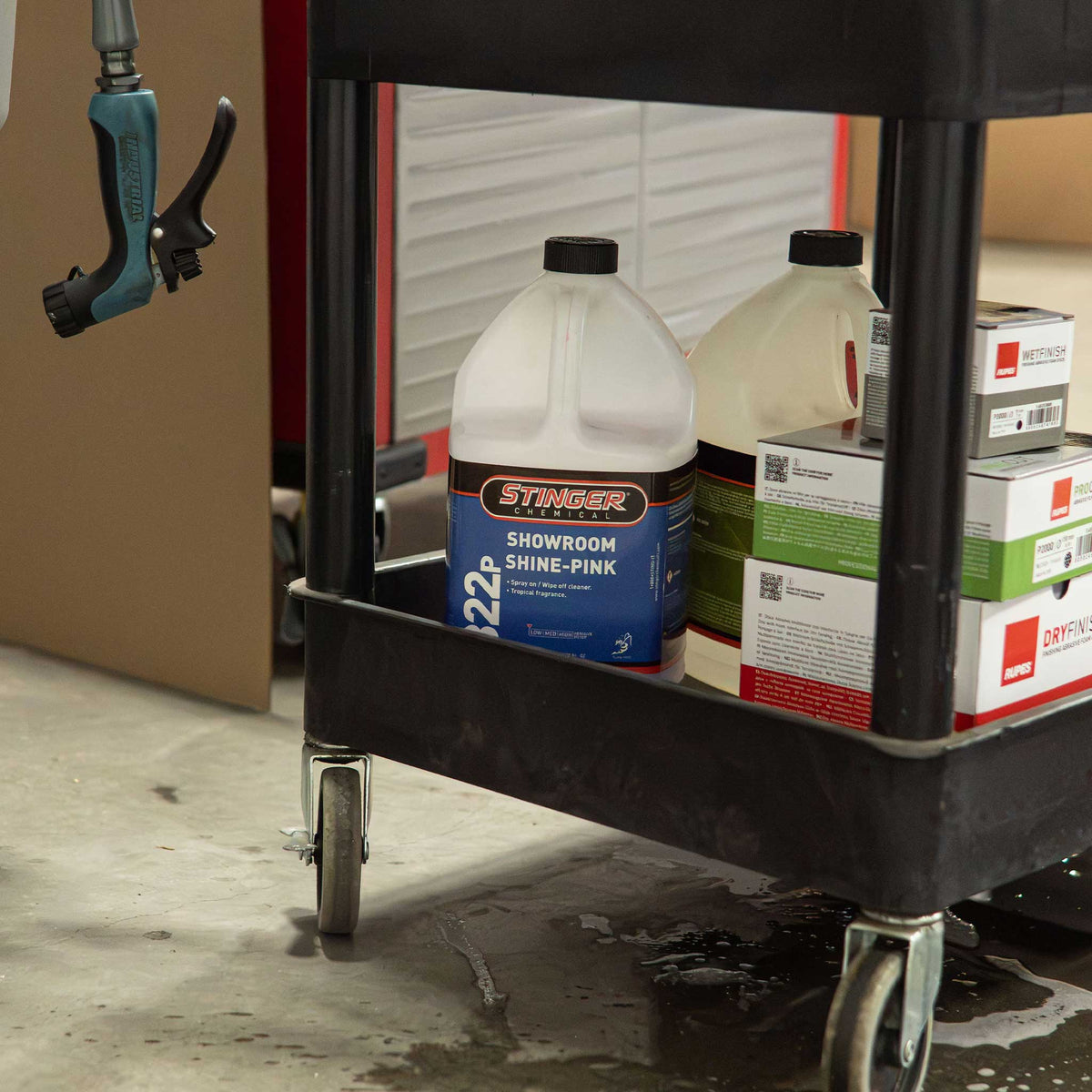 Stinger Chemical Gallon of Showroom shine in a detailing cart in the shop