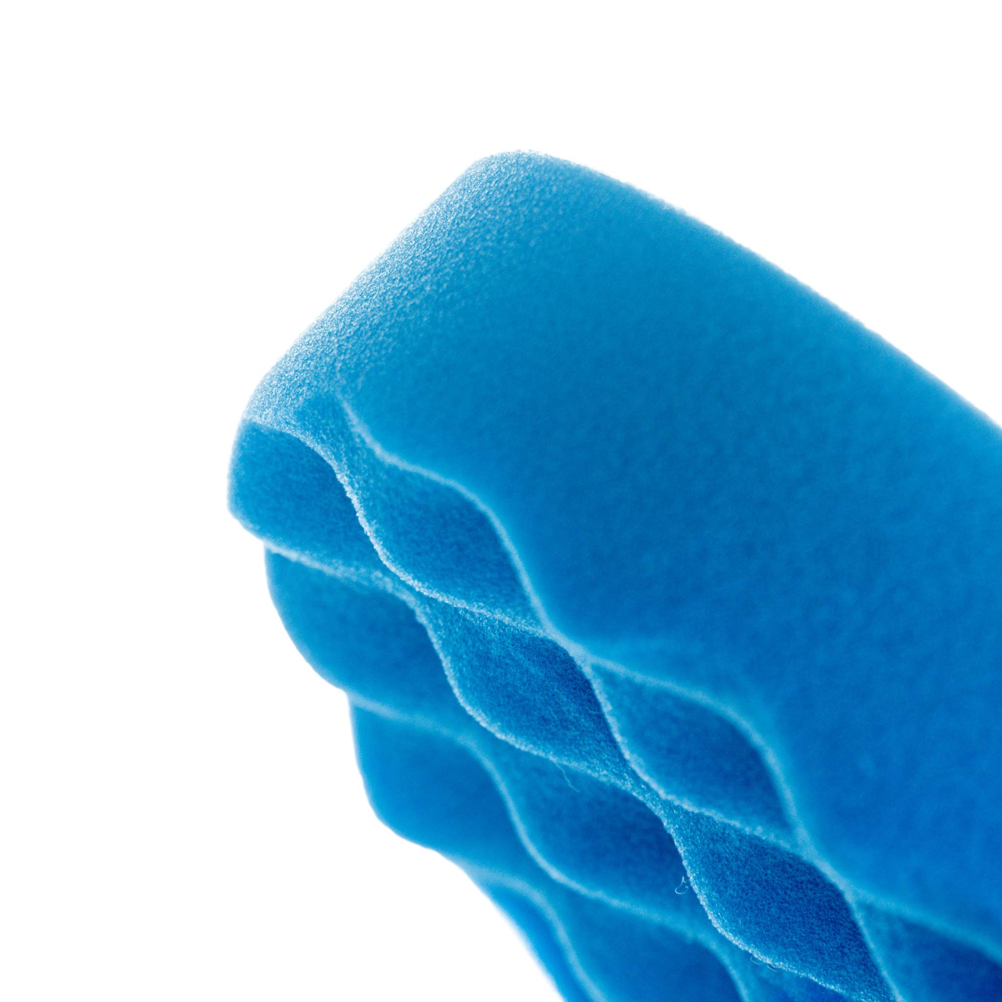 Close-up of a blue foam waffle pad on a white background