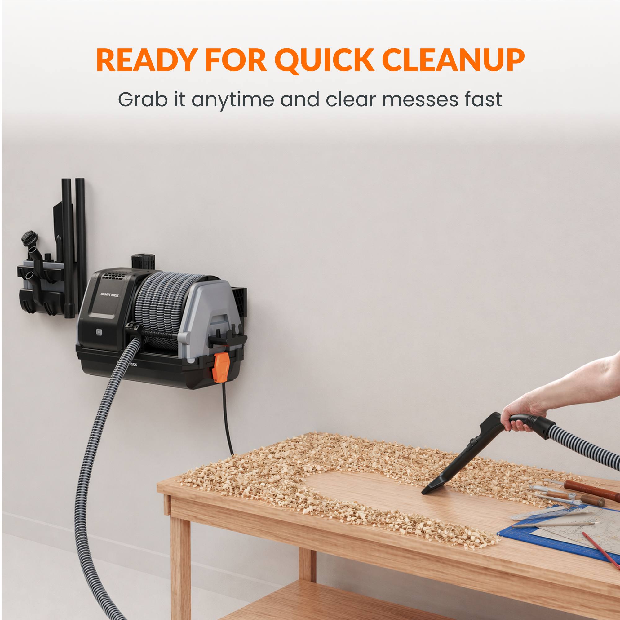 Vacuum cleaner mounted on a wall with a person using it to clean a wooden surface.
