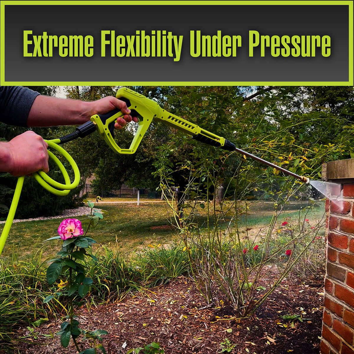 Person using a high-pressure washer to clean plants and a brick wall with text 'Extreme Flexibility Under Pressure' above.
