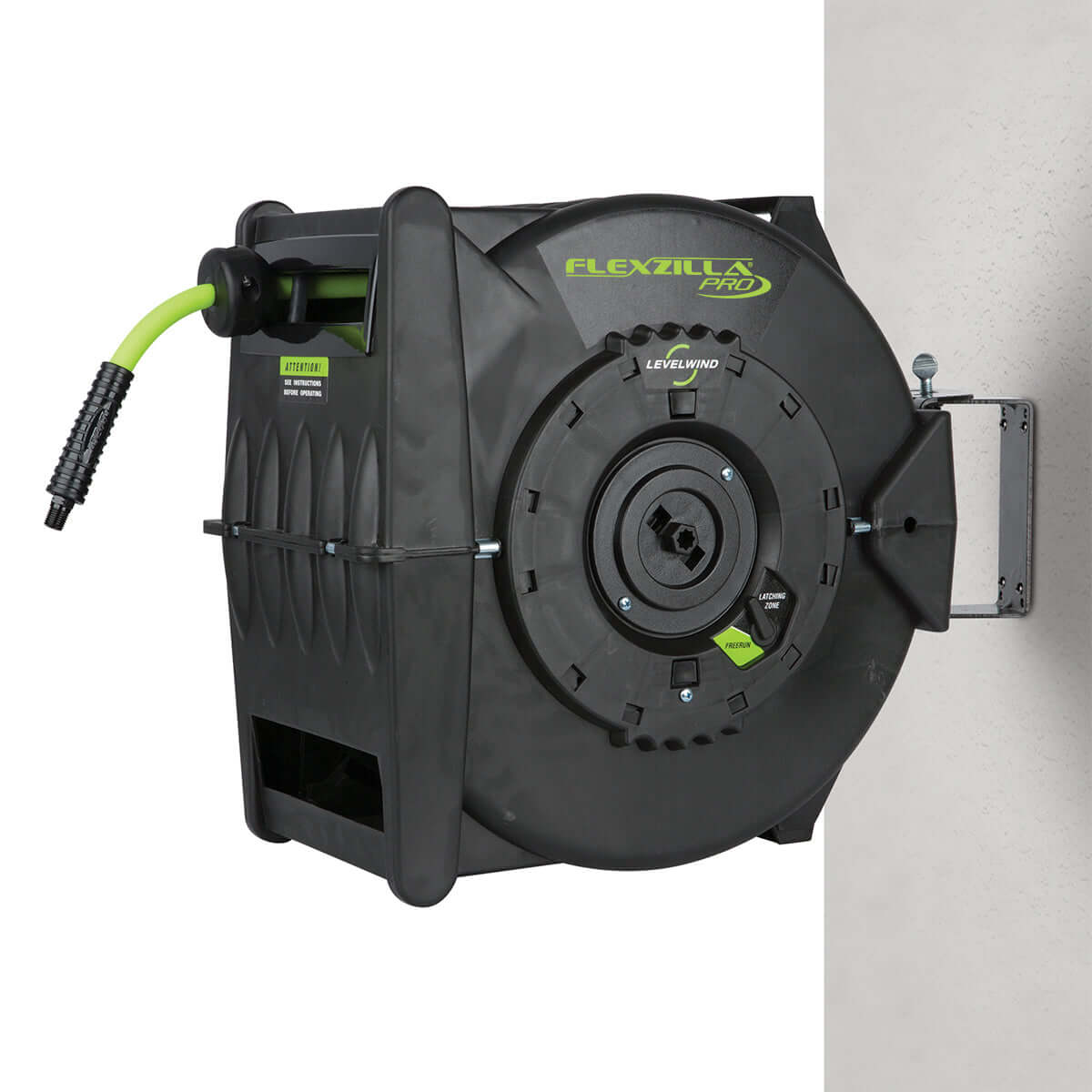 Black Flexzilla Pro hose reel with green hose hung up on a white background
