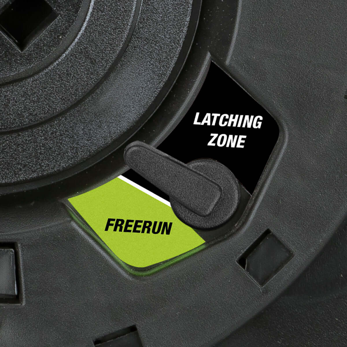 Close-up of a black and green mechanism with 'Latching Zone' and 'Freerun' labels.