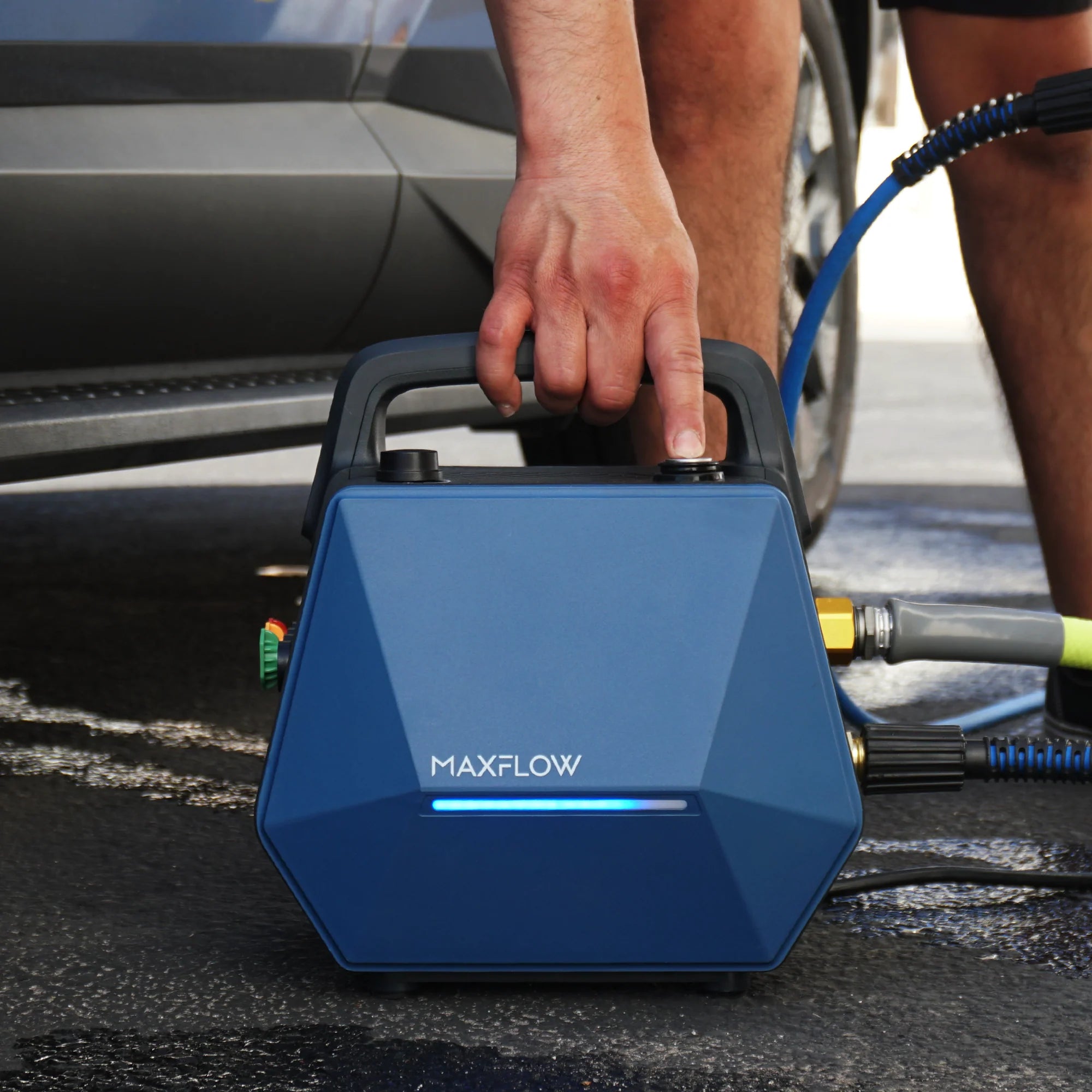 Blue MAXFLOW pressure washer being used outdoors