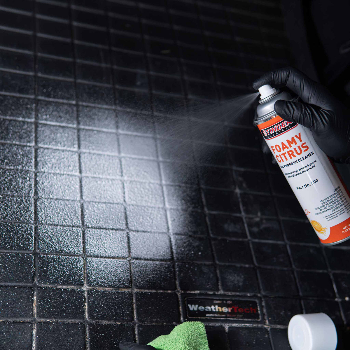Stinger Chemical Foamy Citrus 600 sprayed on a WeatherTech rubber floor mat with a microfiber towel