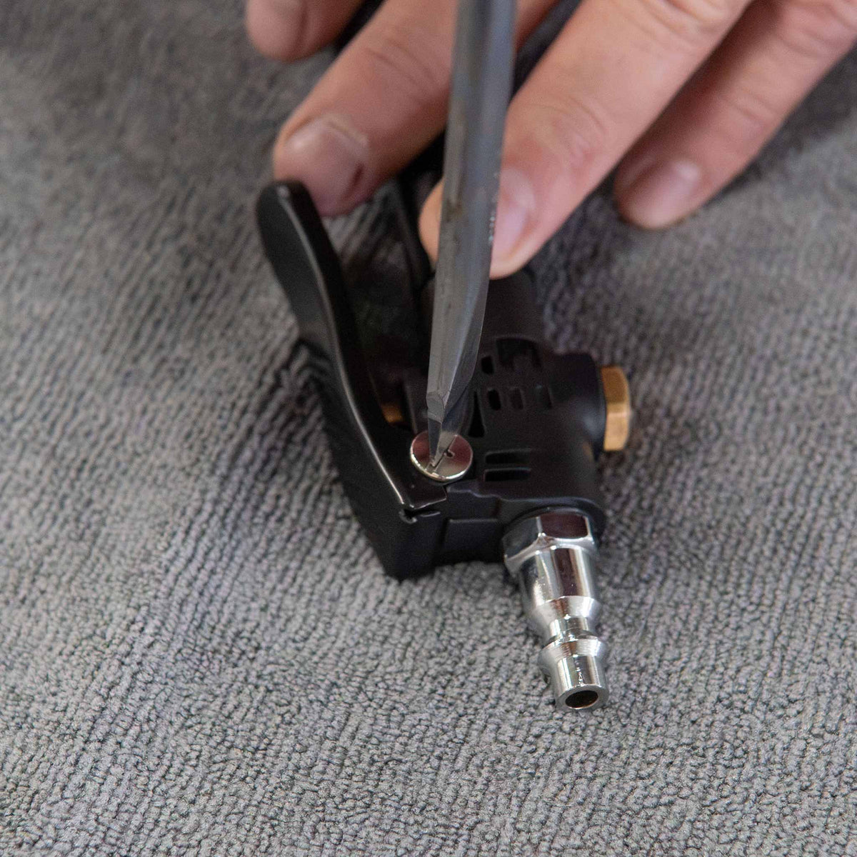Removing the Twister trigger pin screw with a Phillips screwdriver