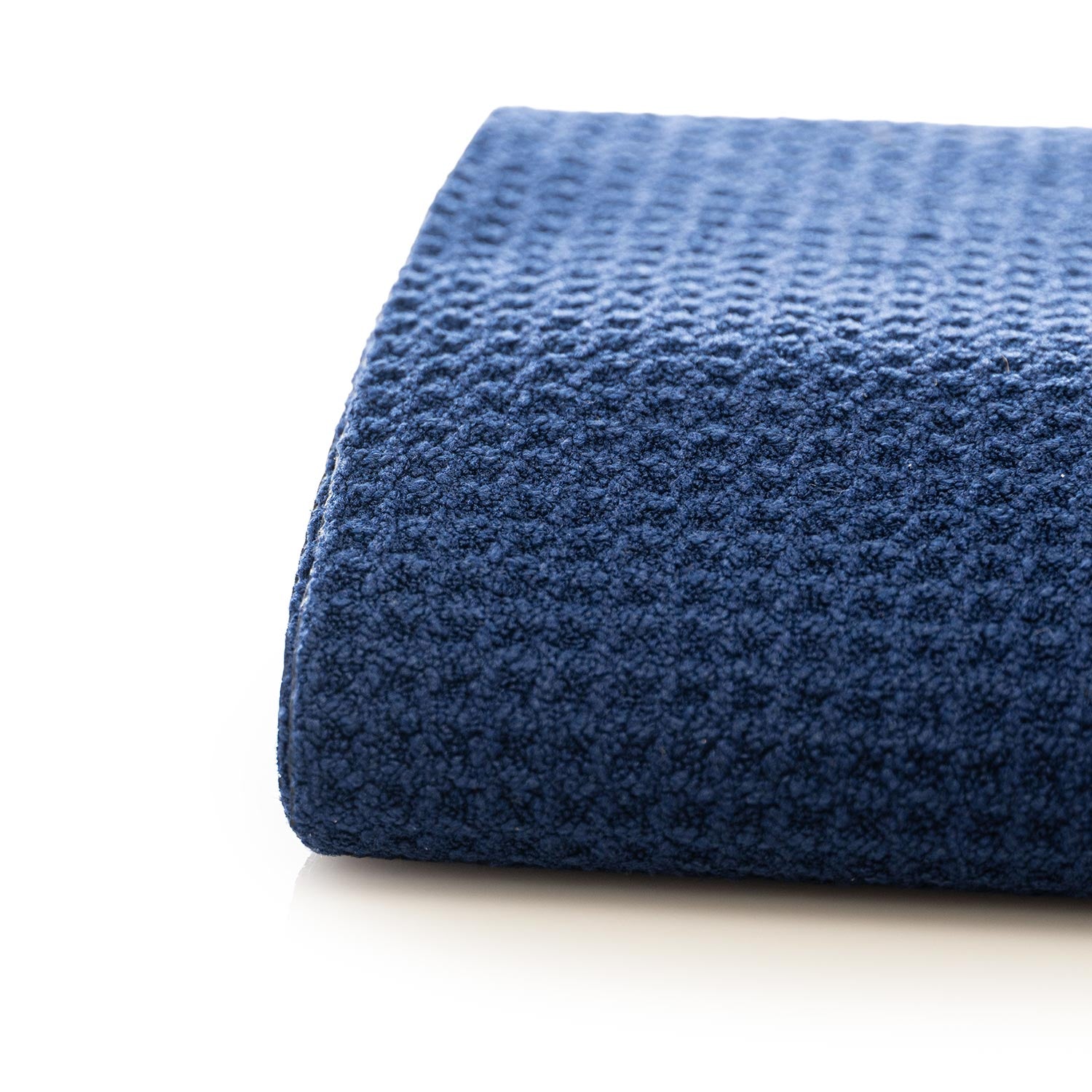 Dark Blue waffle drying towel close up weave on a white background