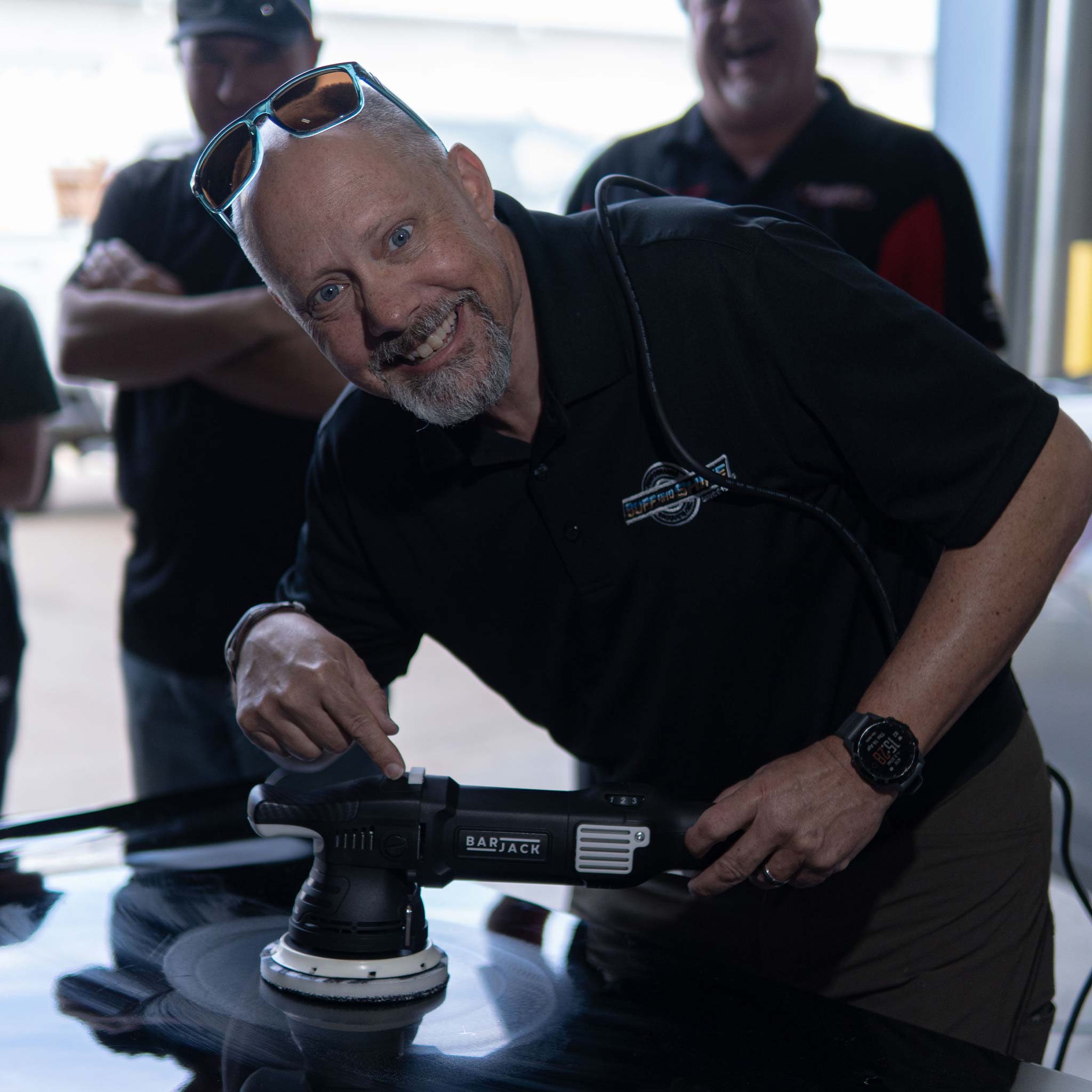 keith duplessie using a barjack polisher on a training car hood
