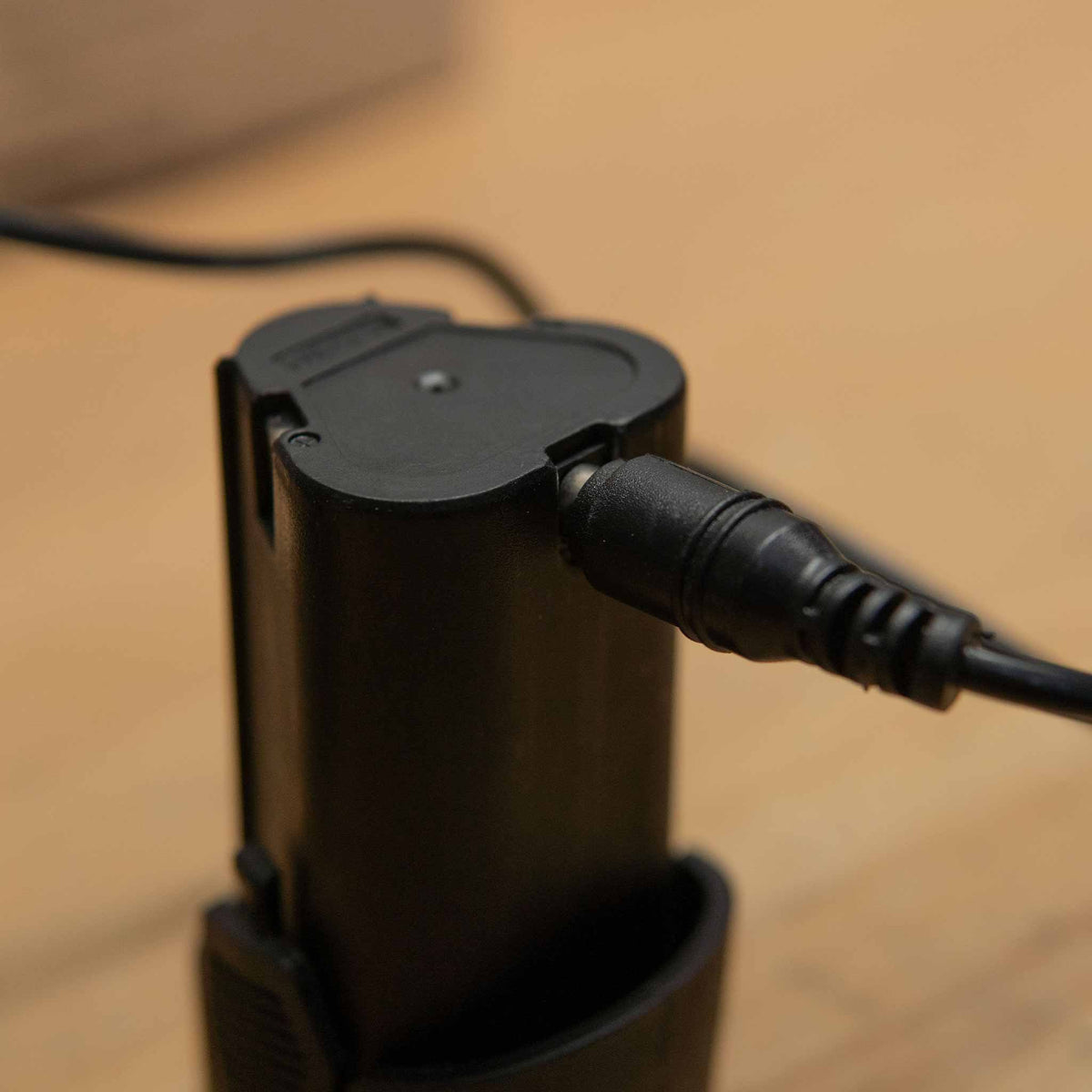 Barjack charger barrel plug connected to the charging port on a Raven 2.5Ah battery