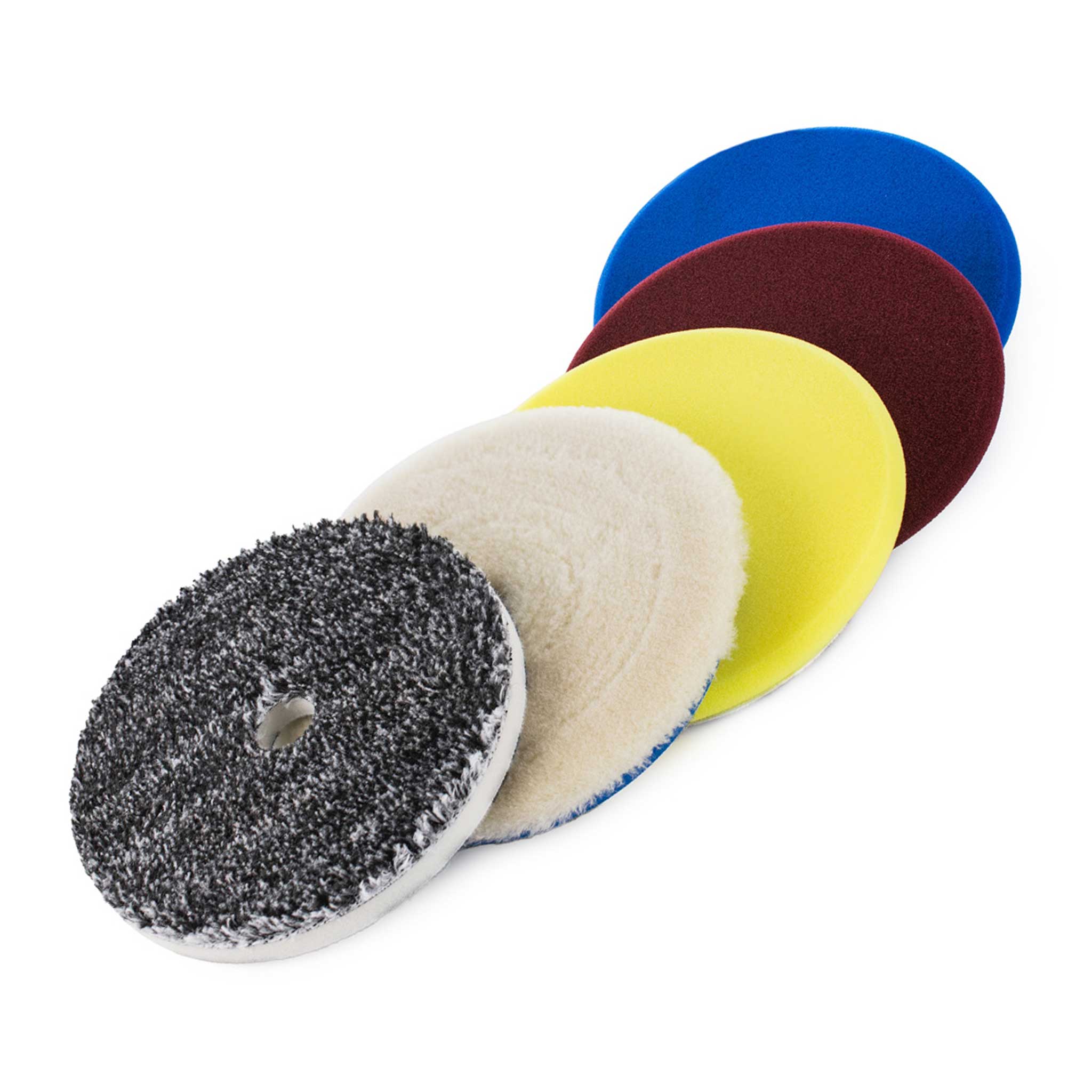 Set of five different colored buffing pads on a white background