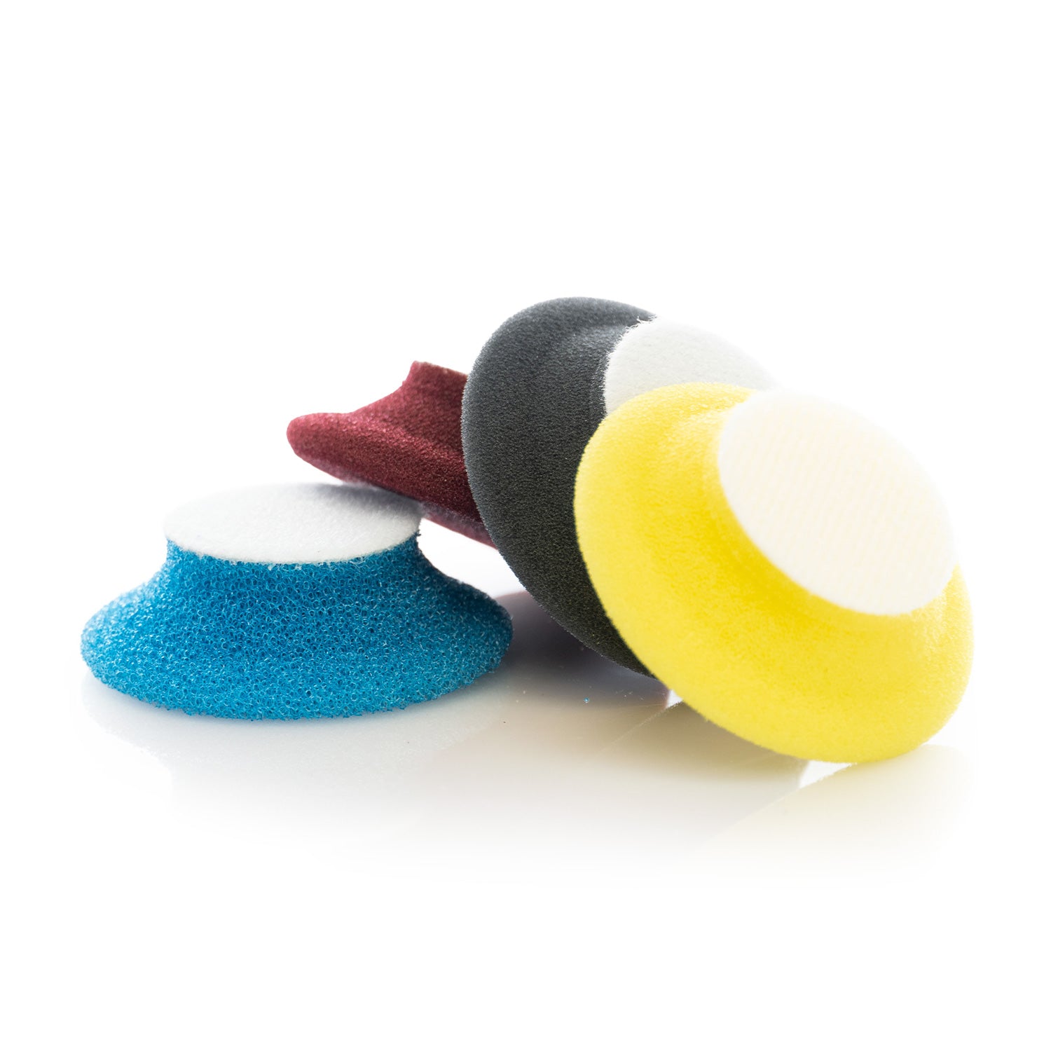 four colorful buffing pads on a white background