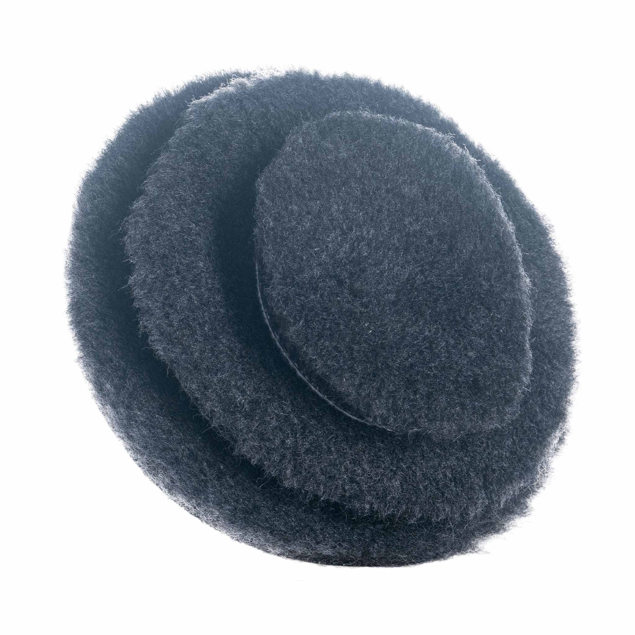 Dark grey wool pads on a white background