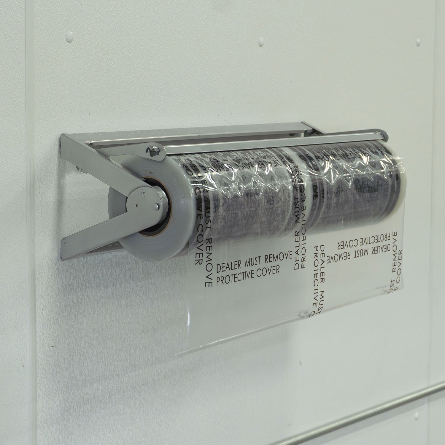 Roll of clear plastic carpet film with a dispenser on a white background