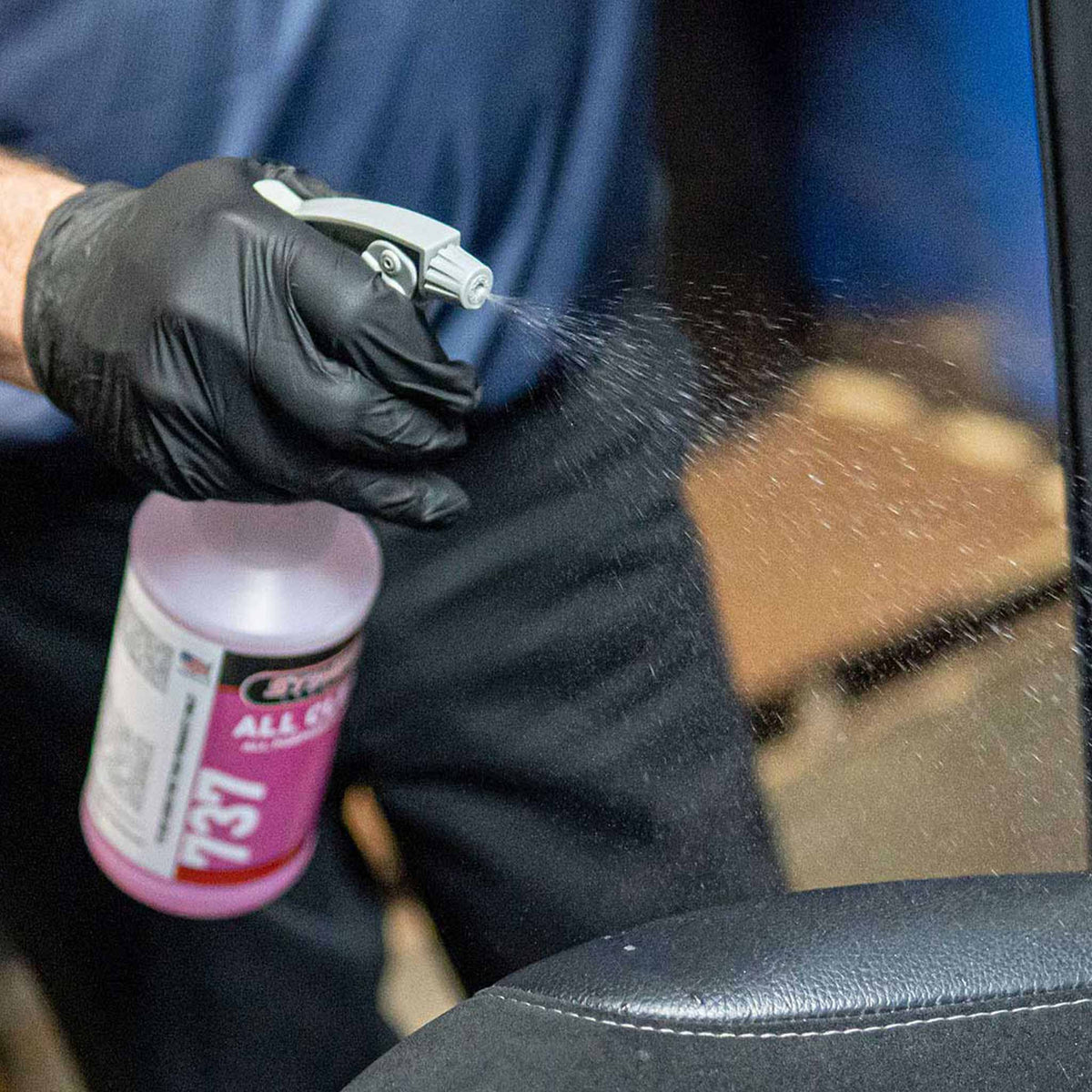 Gray maxi spray head demonstration on a car interior with Stinger Chemical All Clean APC