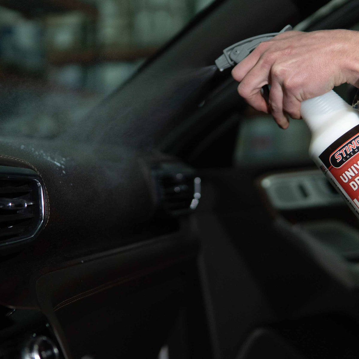Gray maxi spray head demonstration on a car interior leather dash